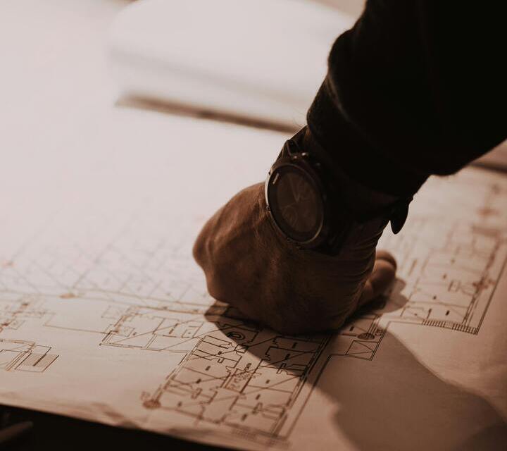 Hand resting on architectural plans